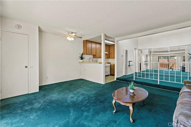 17900 Sherman Way Unit 416, Reseda, CA 91335 - unfurnished living room with carpet, ceiling fan, a textured ceiling, and a sink