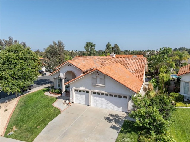 31436 Corte Sonora, Temecula, CA 92592 - mediterranean / spanish house with a tiled roof, stucco siding, a garage, driveway, and a front lawn