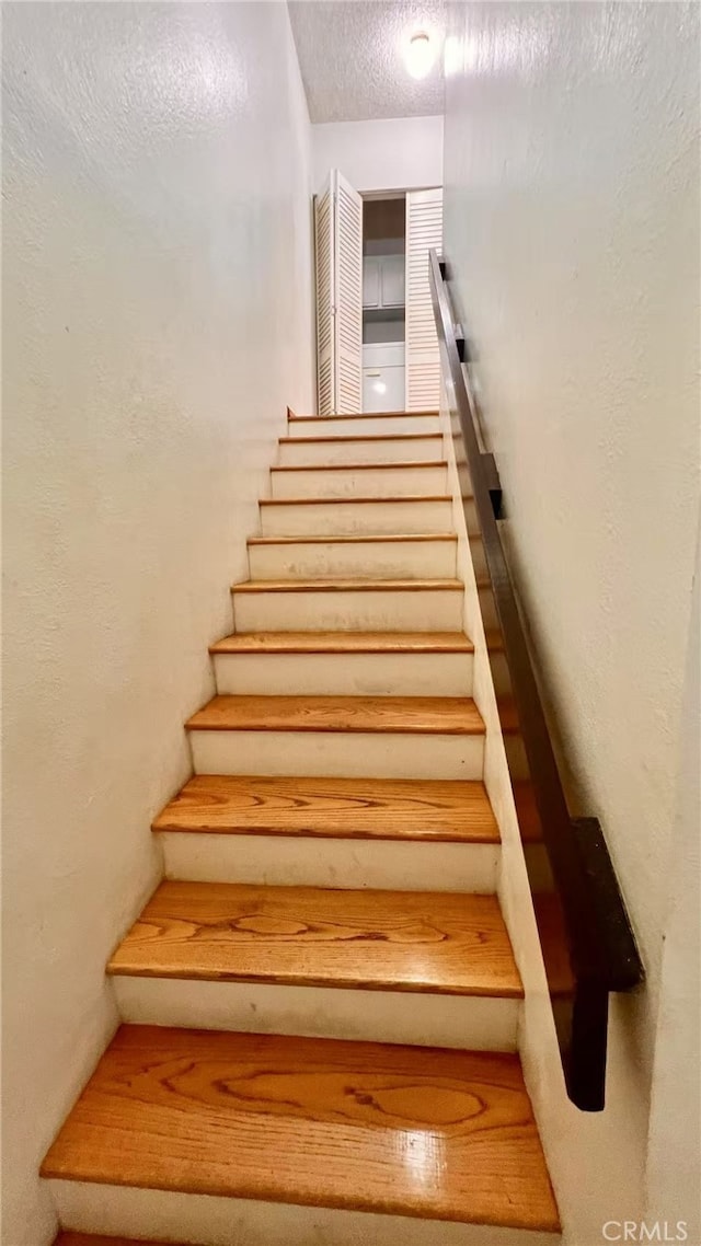 445 W Duarte Rd Unit 5, Arcadia, CA 91007 - staircase featuring a textured ceiling