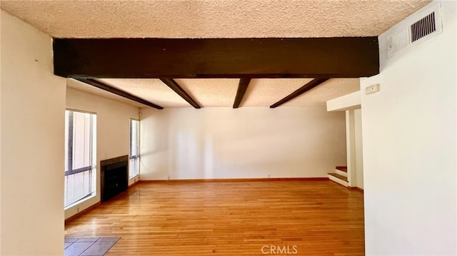 445 W Duarte Rd Unit 5, Arcadia, CA 91007 - unfurnished living room featuring a fireplace, stairs, wood finished floors, and a textured ceiling