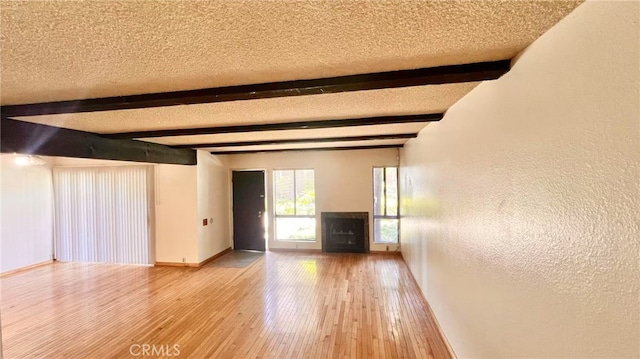 445 W Duarte Rd Unit 5, Arcadia, CA 91007 - unfurnished living room featuring beam ceiling, wood-type flooring, a textured ceiling, and a textured wall
