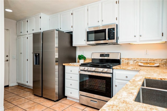 382 Settlers Rd, Upland, CA 91786 - kitchen with appliances with stainless steel finishes, light tile patterned floors, white cabinets, a sink, and recessed lighting