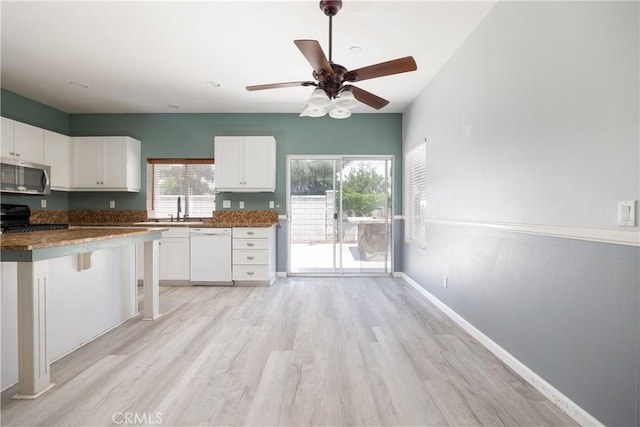 31460 Tulette Ln, Winchester, CA 92596 - kitchen with stainless steel microwave, white dishwasher, range, a sink, and light wood-style floors