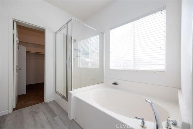 31460 Tulette Ln, Winchester, CA 92596 - full bathroom featuring a stall shower, wood finished floors, a garden tub, and a spacious closet
