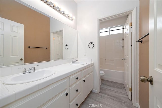 31460 Tulette Ln, Winchester, CA 92596 - full bath with double vanity, toilet, wood finished floors, bathing tub / shower combination, and baseboards