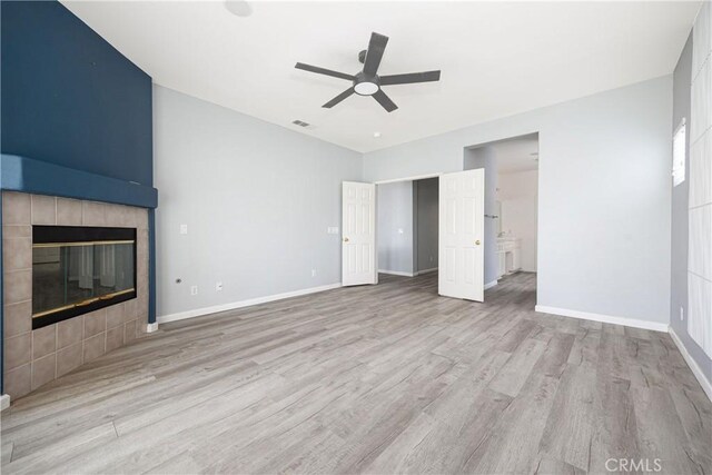 31460 Tulette Ln, Winchester, CA 92596 - unfurnished living room with wood finished floors, ceiling fan, a tile fireplace, and baseboards