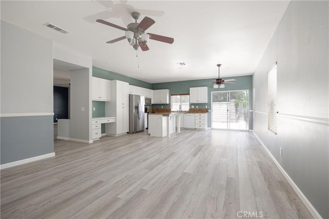 31460 Tulette Ln, Winchester, CA 92596 - unfurnished living room featuring a ceiling fan, light wood-style flooring, baseboards, and a sink
