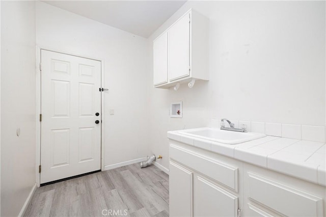 31460 Tulette Ln, Winchester, CA 92596 - laundry area with cabinet space, light wood-style floors, hookup for a washing machine, and baseboards