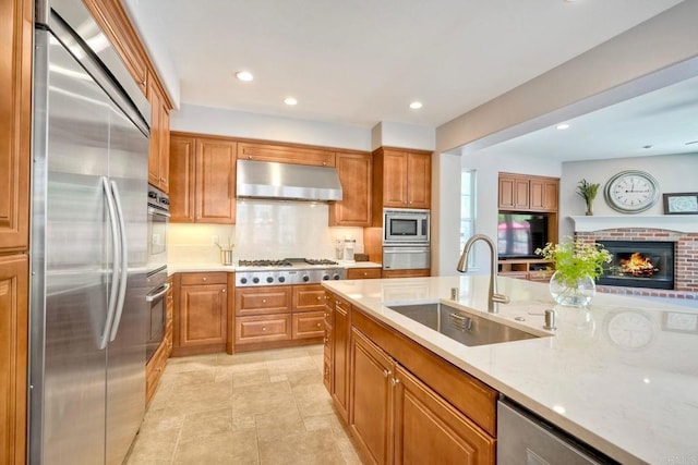 3522 Camino Cereza, Carlsbad, CA 92009 - kitchen featuring built in appliances, exhaust hood, a sink, a fireplace, and recessed lighting