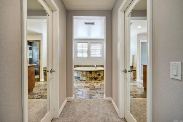 3522 Camino Cereza, Carlsbad, CA 92009 - hall featuring arched walkways, stone tile flooring, and carpet