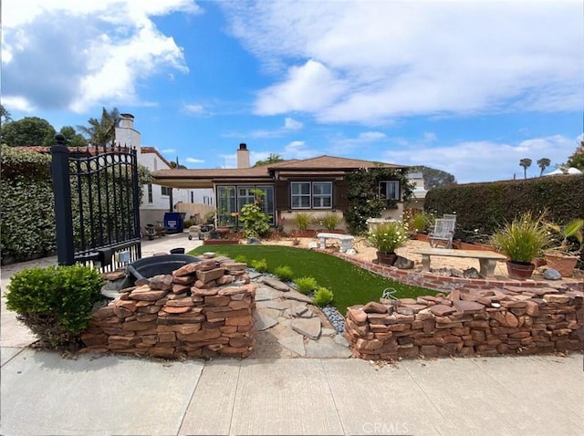 405 Waterview, Playa Del Rey, CA 90293 - back of property featuring a chimney and a gate