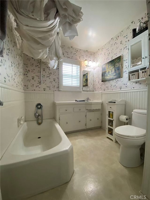 405 Waterview, Playa Del Rey, CA 90293 - bathroom featuring wallpapered walls, wainscoting, a bath, toilet, and vanity