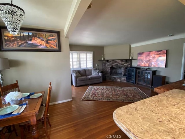 405 Waterview, Playa Del Rey, CA 90293 - living room featuring a chandelier, wood finished floors, a stone fireplace, and baseboards