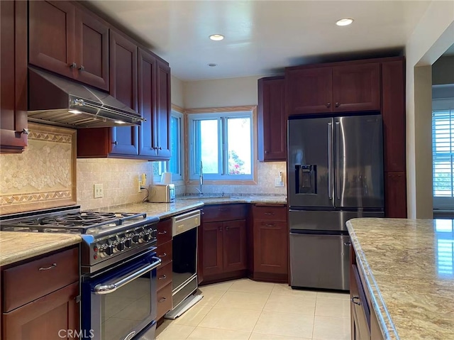 405 Waterview, Playa Del Rey, CA 90293 - kitchen featuring stainless steel appliances, under cabinet range hood, light tile patterned floors, a sink, and decorative backsplash