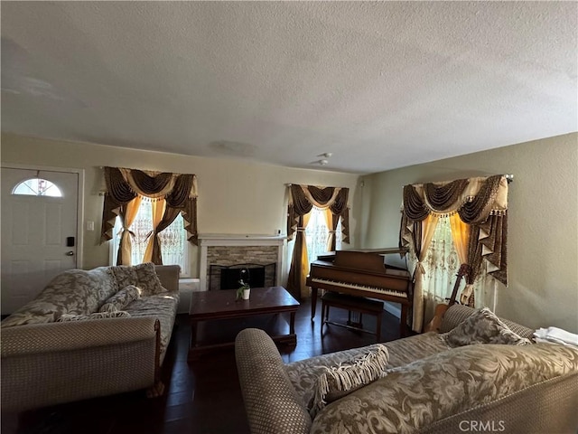 19549 Schoolcraft St, Reseda, CA 91335 - living area featuring wood finished floors, a textured ceiling, and a stone fireplace