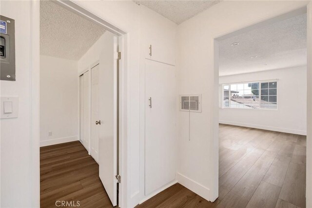 11726 Freeman Ave Unit A, Hawthorne, CA 90250 - corridor featuring a textured ceiling, dark wood-style flooring, baseboards, and electric panel
