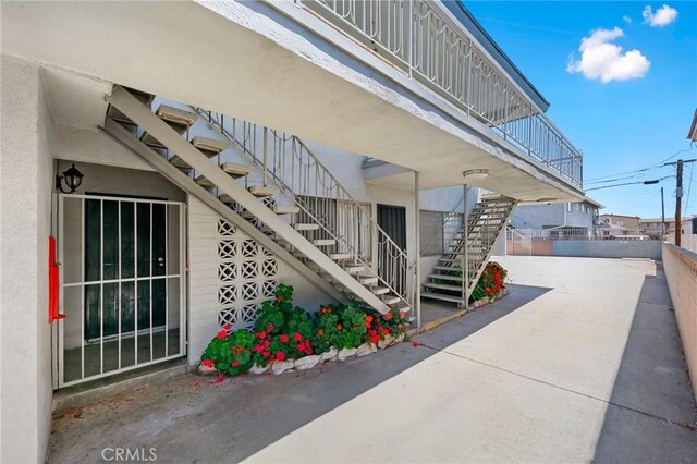 11726 Freeman Ave Unit A, Hawthorne, CA 90250 - view of side of property featuring stairs, a patio, and stucco siding