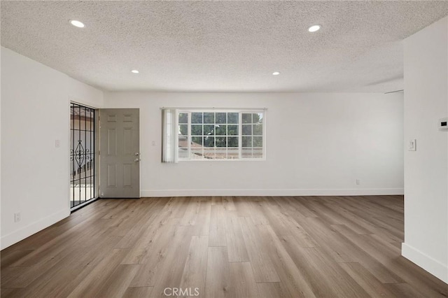 11726 Freeman Ave Unit A, Hawthorne, CA 90250 - empty room featuring wood finished floors, a textured ceiling, baseboards, and recessed lighting