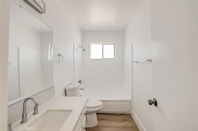 11726 Freeman Ave Unit A, Hawthorne, CA 90250 - bathroom with toilet, vanity, bathtub / shower combination, wood finished floors, and baseboards