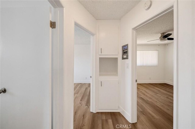 11726 Freeman Ave Unit A, Hawthorne, CA 90250 - hall featuring a textured ceiling, wood finished floors, and baseboards