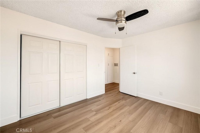 11726 Freeman Ave Unit A, Hawthorne, CA 90250 - unfurnished bedroom with light wood finished floors, a textured ceiling, a closet, baseboards, and ceiling fan