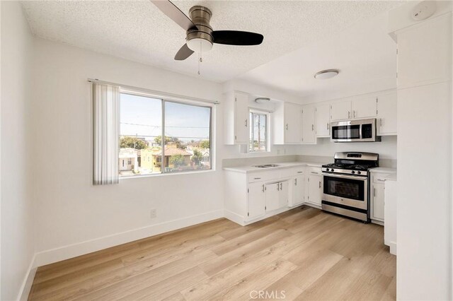 11726 Freeman Ave Unit A, Hawthorne, CA 90250 - kitchen featuring appliances with stainless steel finishes, light countertops, light wood-type flooring, ceiling fan, and baseboards