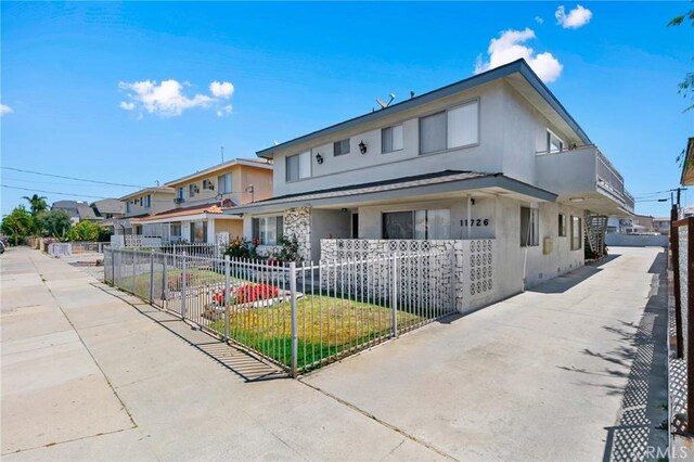 11726 Freeman Ave Unit A, Hawthorne, CA 90250 - view of front facade featuring a fenced front yard, stucco siding, and a porch