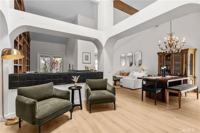 24232 Porto Nuovo, Dana Point, CA 92629 - living room featuring a towering ceiling, a chandelier, and wood finished floors