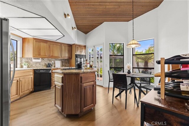 24232 Porto Nuovo, Dana Point, CA 92629 - kitchen featuring black appliances, plenty of natural light, a kitchen island, light wood-style flooring, and high vaulted ceiling