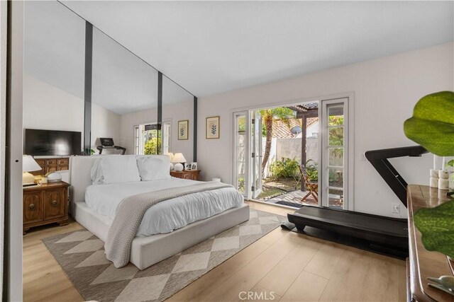 24232 Porto Nuovo, Dana Point, CA 92629 - bedroom featuring access to exterior, light wood-type flooring, and vaulted ceiling
