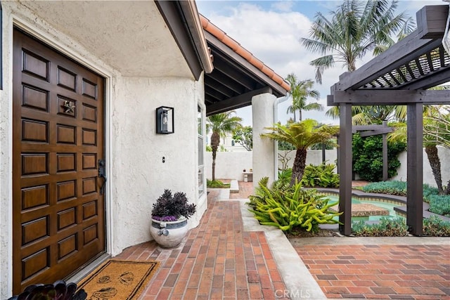 24232 Porto Nuovo, Dana Point, CA 92629 - property entrance with stucco siding, an outdoor pool, and a pergola