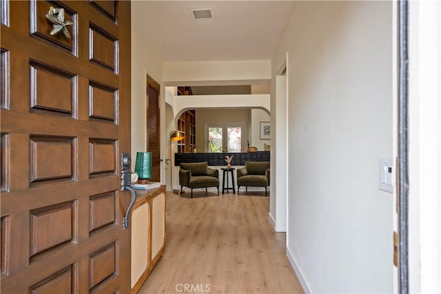 24232 Porto Nuovo, Dana Point, CA 92629 - foyer with arched walkways, light wood-type flooring, and baseboards