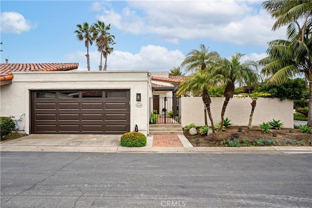 24232 Porto Nuovo, Dana Point, CA 92629 - mediterranean / spanish-style house with a garage, a tile roof, stucco siding, and concrete driveway
