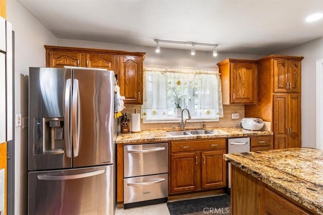 19921 Rambling Rd, Covina, CA 91724 - kitchen featuring stainless steel appliances, a sink, and brown cabinets