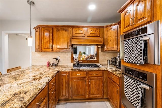 19921 Rambling Rd, Covina, CA 91724 - kitchen with light stone countertops, tasteful backsplash, appliances with stainless steel finishes, and brown cabinetry