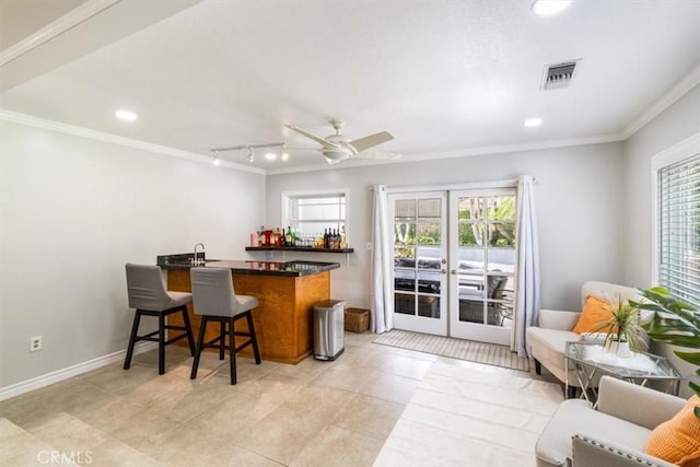 19921 Rambling Rd, Covina, CA 91724 - kitchen with crown molding, healthy amount of natural light, a breakfast bar area, a peninsula, and ceiling fan