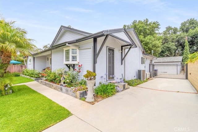 19921 Rambling Rd, Covina, CA 91724 - view of front of home with driveway, stucco siding, central AC unit, and a gate