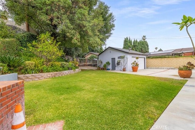 19921 Rambling Rd, Covina, CA 91724 - view of yard featuring a garage, an outbuilding, and driveway