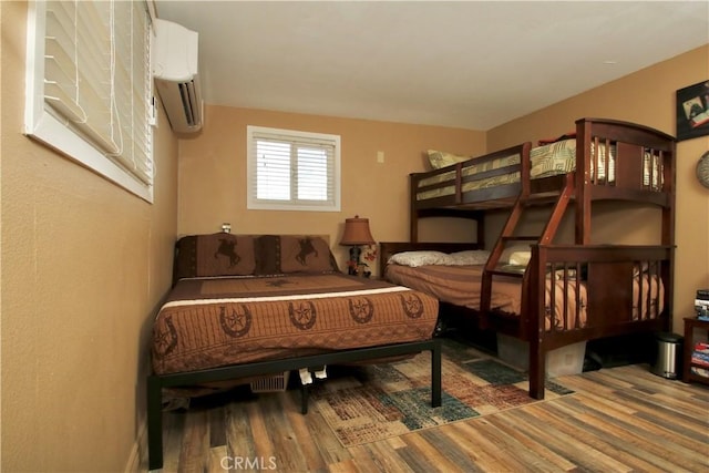 1910 Artesia Ave, Landers, CA 92285 - bedroom featuring wood finished floors and a wall mounted AC