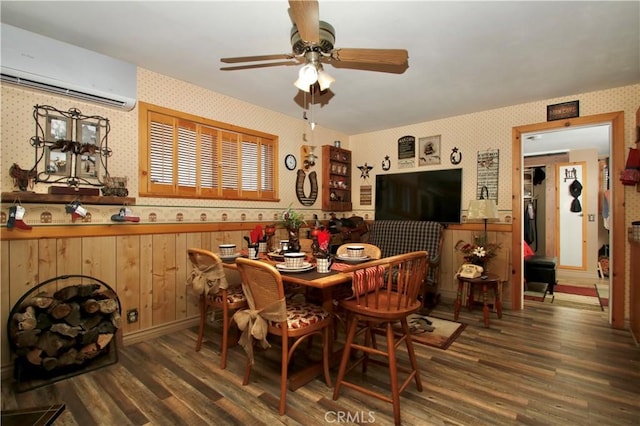 1910 Artesia Ave, Landers, CA 92285 - dining area with wallpapered walls, an AC wall unit, wood finished floors, a ceiling fan, and a wainscoted wall