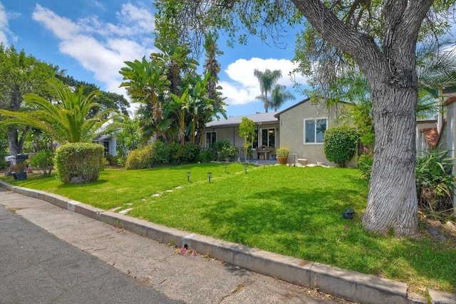 118 W 11th Ave, Escondido, CA 92025 - view of front facade with stucco siding and a front lawn