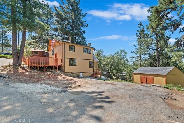 26745 Hopkins Rd, Idyllwild, CA 92549 - view of property exterior featuring a deck, an outdoor structure, and a garage