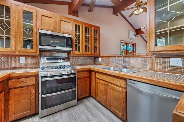 26745 Hopkins Rd, Idyllwild, CA 92549 - kitchen featuring stainless steel appliances, a sink, backsplash, light wood finished floors, and brown cabinets