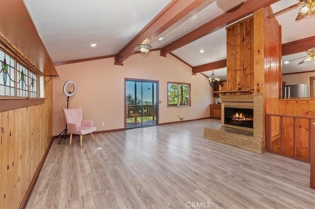 26745 Hopkins Rd, Idyllwild, CA 92549 - unfurnished living room featuring ceiling fan, wood finished floors, a brick fireplace, baseboards, and wood walls