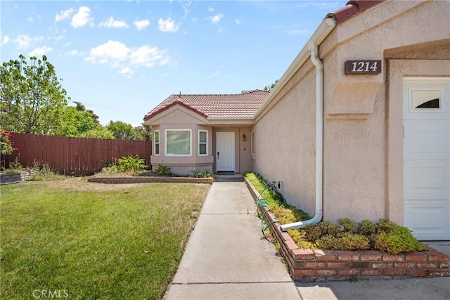 1214 Mallorca St, Upland, CA 91784 - entrance to property featuring stucco siding, a tiled roof, and a garage