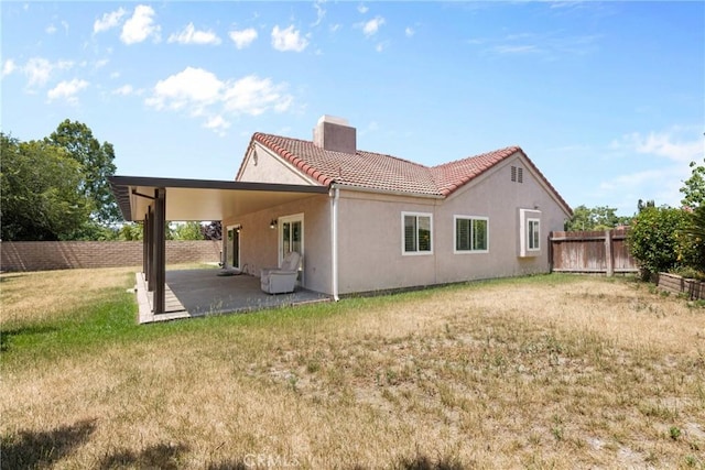1214 Mallorca St, Upland, CA 91784 - back of property featuring a chimney, a tile roof, stucco siding, and a patio area