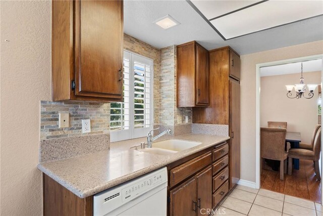 1214 Mallorca St, Upland, CA 91784 - kitchen with dishwasher, a sink, brown cabinetry, light tile patterned floors, and light countertops