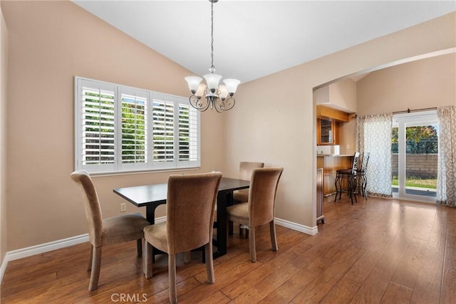1214 Mallorca St, Upland, CA 91784 - dining room featuring a chandelier, vaulted ceiling, hardwood / wood-style floors, and baseboards