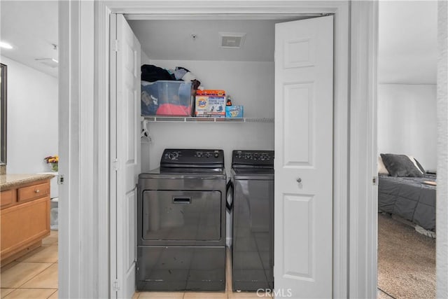 1023 Vista Del Cerro Dr Unit 205, Corona, CA 92879 - washroom featuring washing machine and clothes dryer and light tile patterned floors