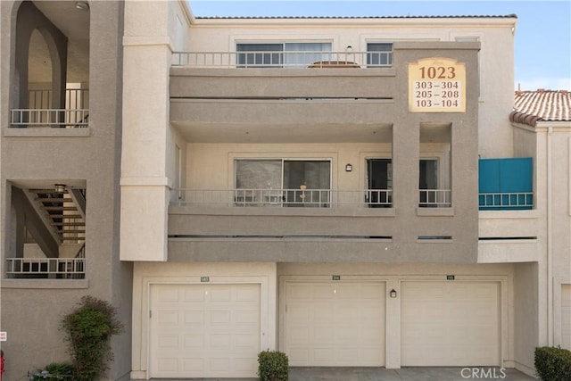 1023 Vista Del Cerro Dr Unit 205, Corona, CA 92879 - view of building exterior with an attached garage